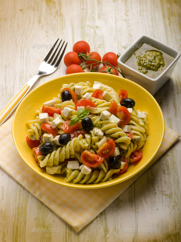 pasta salad with pesto feta tomatoes and black olives Stock Photo by